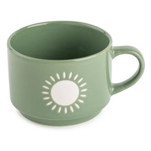 Ceramic coffee mug in sage green with sun icon design and side handle
