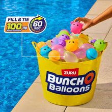 Water balloons in a yellow bucket, including pink, blue, green, and purple