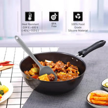 Gray and black silicone spatulas stirring food in a frying pan