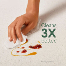 Hand wiping a countertop with a disinfecting wipe to clean up a spill