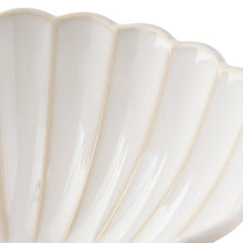 Cream ceramic cereal bowl rim close-up with glazed fluted texture