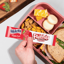 Welch's Fruitfuls strawberry fruit strips box held above snacks