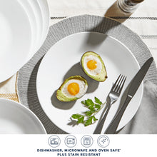 White glass salad plate with two avocado halves and herb garnish