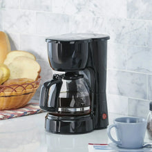 Black 5-cup coffee maker on countertop with glass carafe and measurement marks