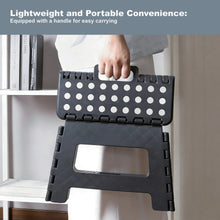 Foldable plastic step stool, black, with carry handle and dot-pattern top for portability