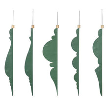Five green honeycomb paper ornaments shown edge-on, revealing their flat folded profiles