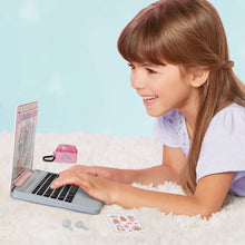 Child using pink pretend laptop with Princess-themed screen and black keyboard