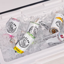 White Claw Hard Seltzer cans in assorted flavors, including pineapple, nestled in ice.