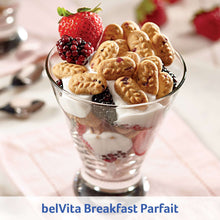 Glass yogurt parfait topped with breakfast biscuits and berries