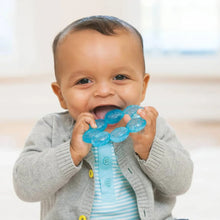 Blue circular water teether in baby’s hands, soft bumpy texture