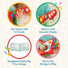 Red toy guitar with colored keys and teal speaker, with open songbook display