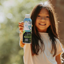 Smiling child holding Trek kids insect repellent continuous spray bottle