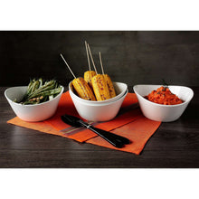 Set of three white wavy porcelain bowls with vegetables and sides