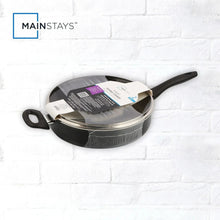 Black non-stick cooker in retail packaging with glass lid visible