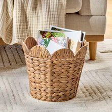 Water hyacinth basket with scalloped rim, woven tan, holds greeting cards