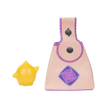 Pale pink doll pouch accessory with purple trim, gem graphic, and dark round details