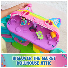 Purple dollhouse top with cat-themed roof and small accessories on surfaces