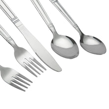 Close-up of stainless steel spoons, knife, and fork tines with patterned handles