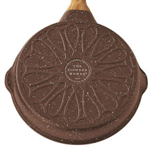 Brown speckled cast aluminum fry pan underside with decorative logo and wooden handle