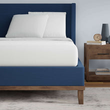 Two white extra-firm cooling bed pillows stacked on a bed