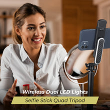 Black selfie stick tripod with phone clamp and LED light panel, secured on a three-leg stand