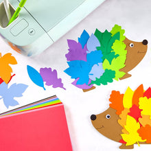 Assorted colorful cardstock cut shapes with 12x12 sheet and craft tools