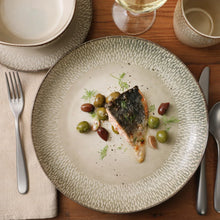 Stoneware dinner plate with reactive glaze, served with herbs and sliced food