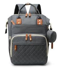 Gray diaper bag backpack with quilted front pocket, zip compartments, and side bottle holders