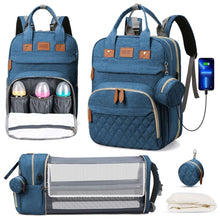 Blue diaper bag backpack open with bottle organizer and fold-out changing pad