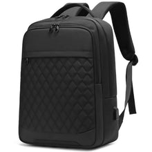 Black laptop backpack with quilted front panel, carry handle, and side zipper pocket.
