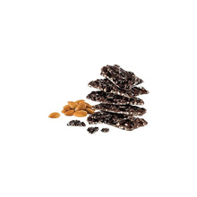 Stack of dark chocolate almond bark with scattered almonds