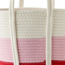 Cotton rope basket close-up: white rope handles over pink and red woven stripes.