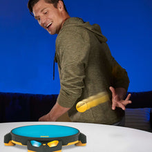Electronic action game base with blue top as a player holds the yellow ball