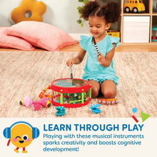 Child playing with a colorful animal toy drum and small rattle and bell instruments