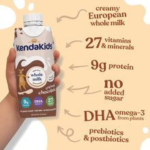 Kids nutrition shake carton in hand, showing whole milk and protein label details