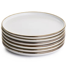 Stacked matt white stoneware salad plates with gold rim