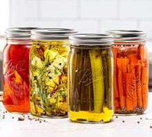 Four Ball wide-mouth mason jars with airtight lids, assorted colorful preserves