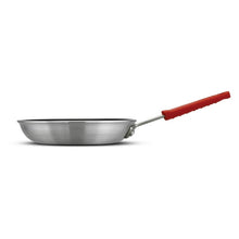 Small nonstick frying pan with black interior and red handle, shown in side profile.
