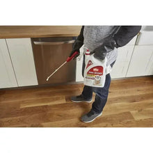 Insect killer sprayer bottle with comfort wand in hand, ready to spray