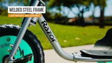 Gray mini tricycle frame with teal front wheel and black tire tread