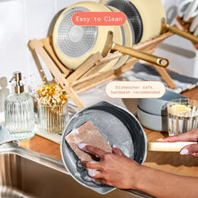 Buttercream skillet being cleaned in sink with sponge and soapy water