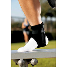 Black ankle support brace worn on foot with lace-up closure