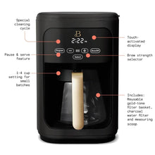 Black programmable drip coffee maker with touch display and gold-tone brew basket.