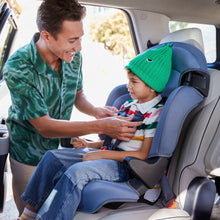 Kids booster car seat in car with child seated, dark blue and light gray upholstery