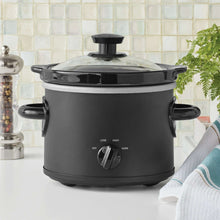 2-quart manual slow cooker with clear glass lid and matte black base, front control dial