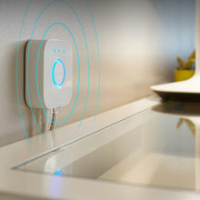 Wall-mounted Philips Hue bridge hub with blue connection light outlines