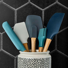 Five beechwood-handled silicone utensils in teal and blue, plus a white spatula head