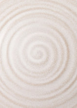 Close-up of stoneware dinner plate with swirl pattern glaze