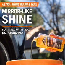 Ultra shine wash and wax bottle held above a car exterior