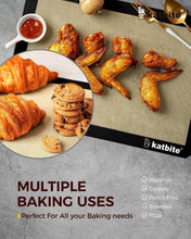 Silicone baking mat with golden baked items, black border, and food on top.